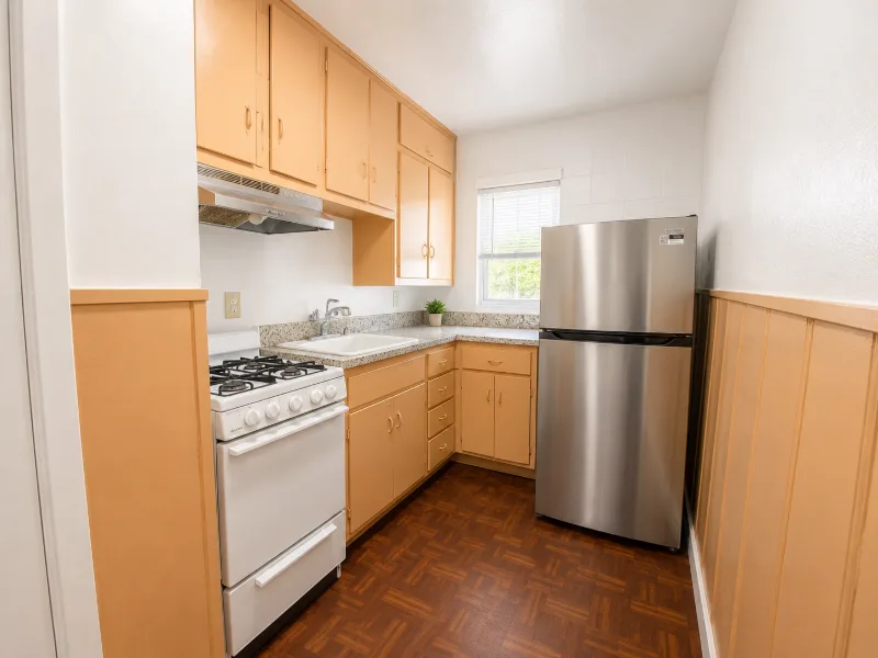 Kitchen with stainless refrigerator and gas range