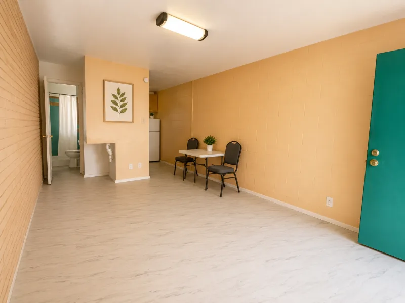 Open efficiency main room with an accent wall and dining nook